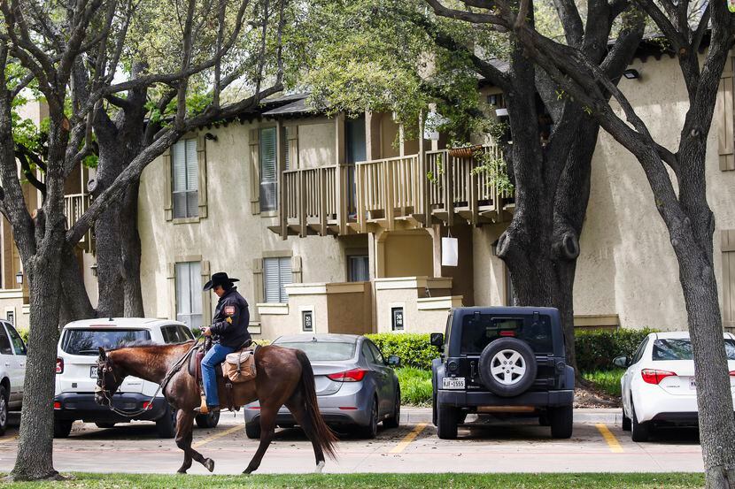 Horseback security guard Staci Smith patrols The Village apartments Wednesday, April 1, 2020...