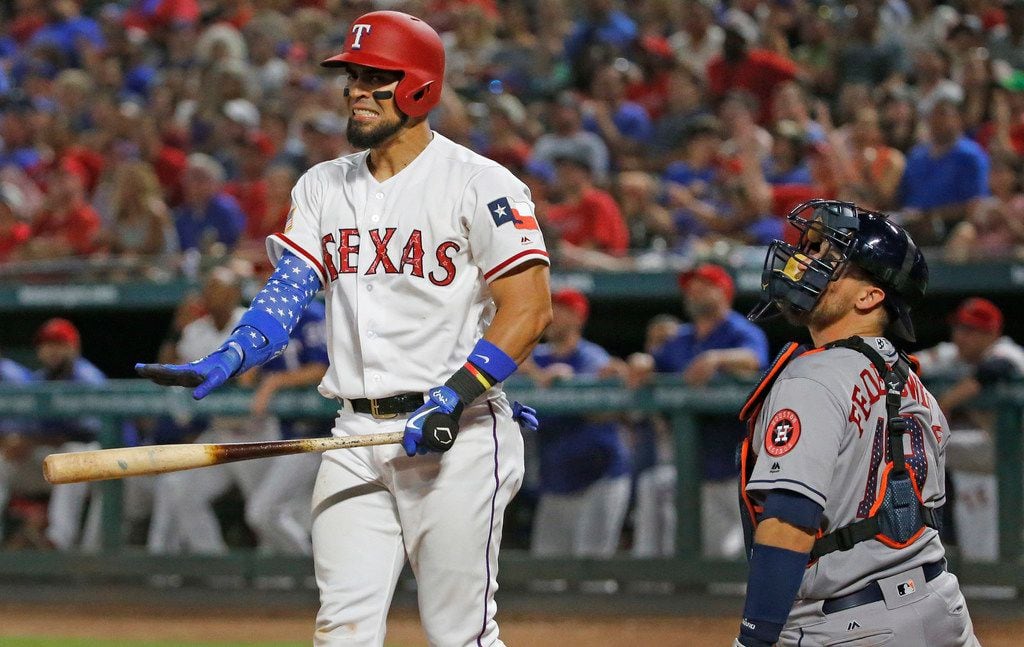 Texas Rangers Robinson Chirinos (61) watches the flight of a long foul fly that he hit with...