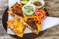 Hurtado Barbecue will sell birria quesadillas made with smoked brisket at Texas Rangers home...