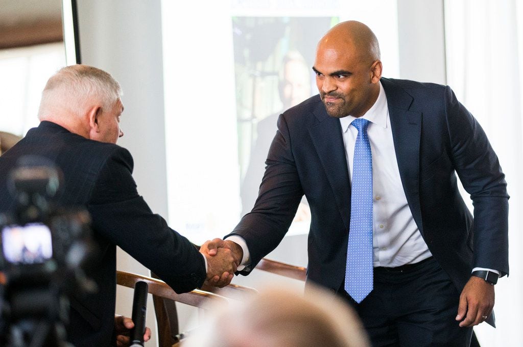 Congressional candidates Colin Allred and Pete Sessions shake hands before a debate at a...