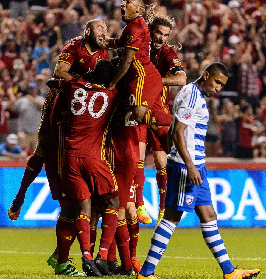 Real Salt Lake players jump on defender Jamison Olave (4) after his goal against FC Dallas...
