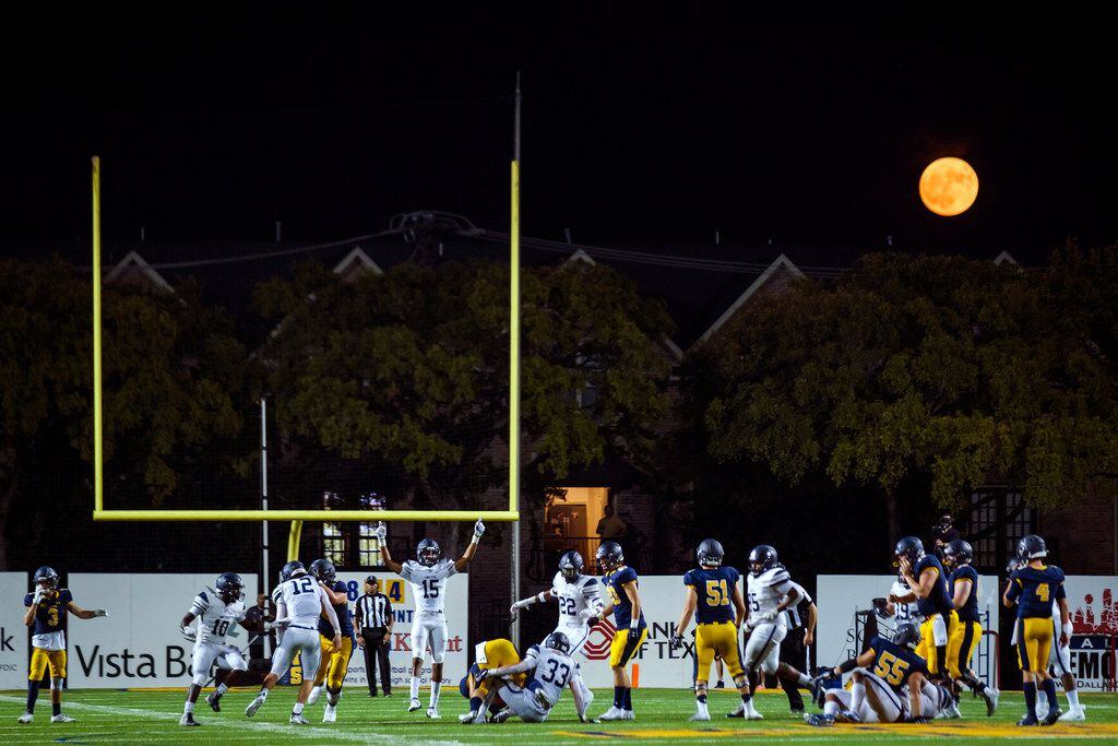 The full moon rises over he stadium as Frisco Lone Star faces Highland Park in a high school...