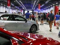 People walk around the auto show during the State Fair of Texas, Sunday, Oct. 2, 2022 at...