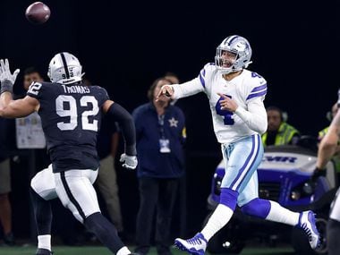 Dallas Cowboys quarterback Dak Prescott (4) throws a pass in overtime as he rolls out against Las Vegas Raiders defensive end Solomon Thomas (92) at AT&T Stadium in Arlington, November 25, 2021. The Cowboys lost in overtime to the Raiders, 36-33.