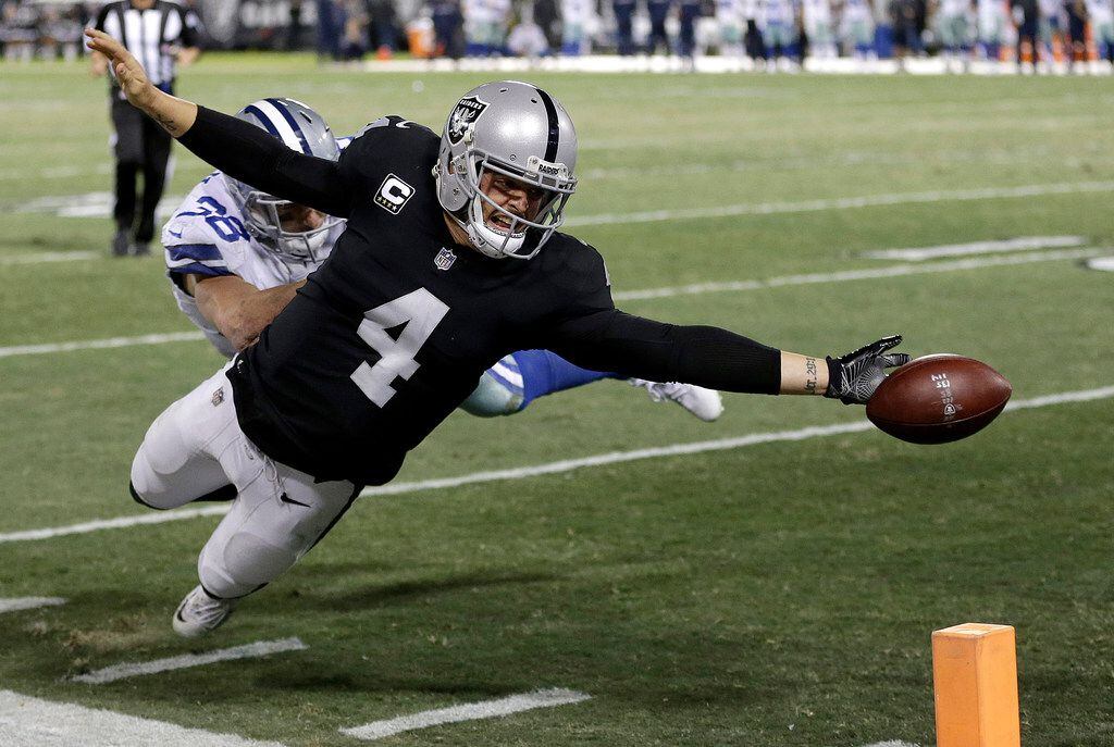 Oakland Raiders quarterback Derek Carr (4) fumbles the ball into the end zone in front of...