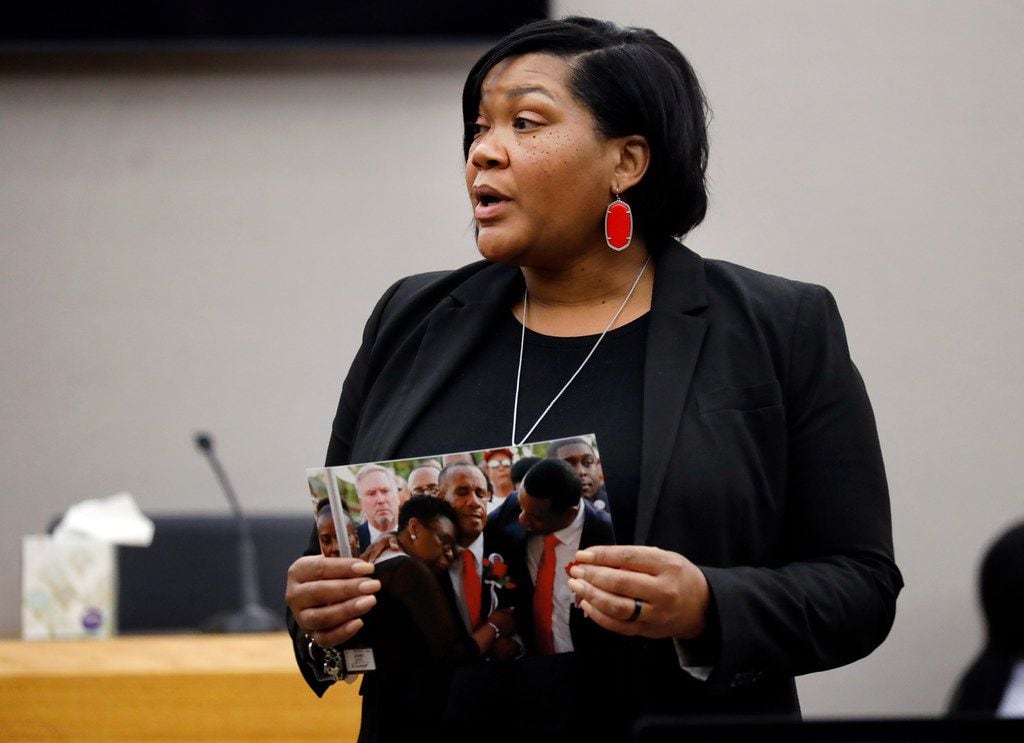 Assistant District Attorney LaQuita Long shows the jury a photo of Botham Jean's parents...