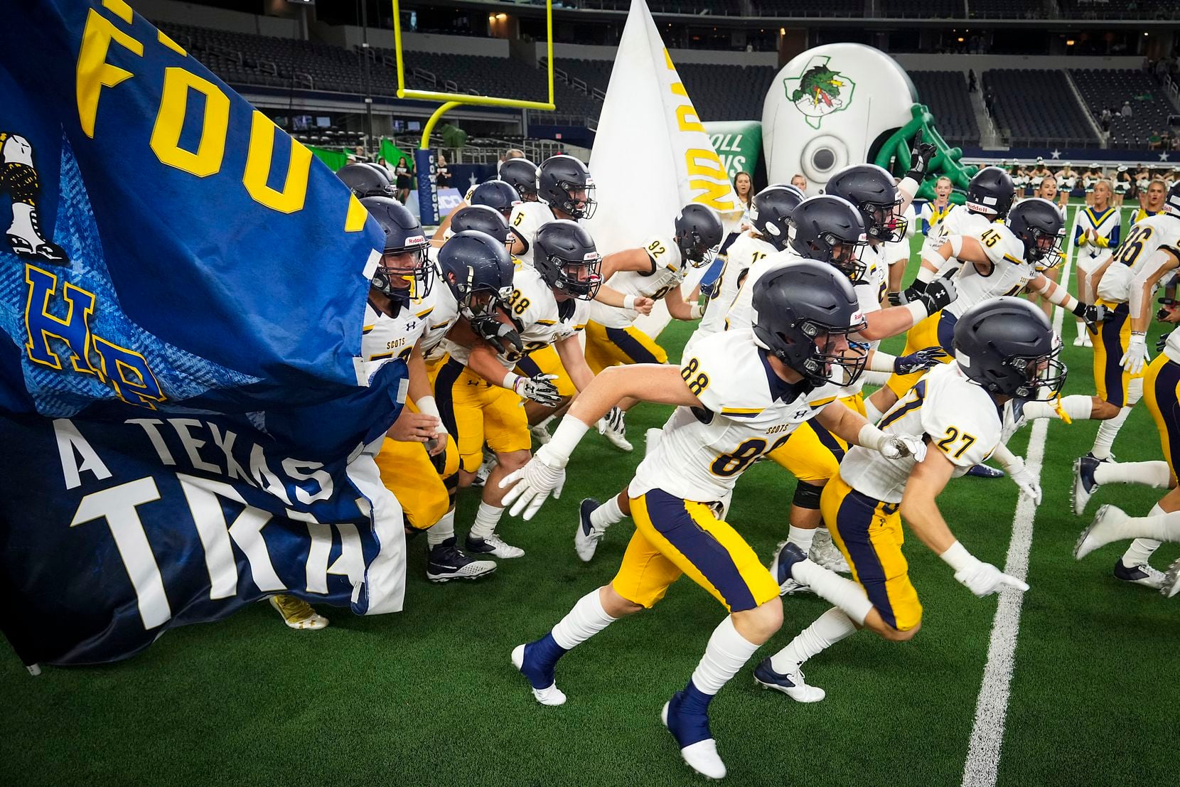 Highland Park players take the field to face Southlake Carroll in a high school football...