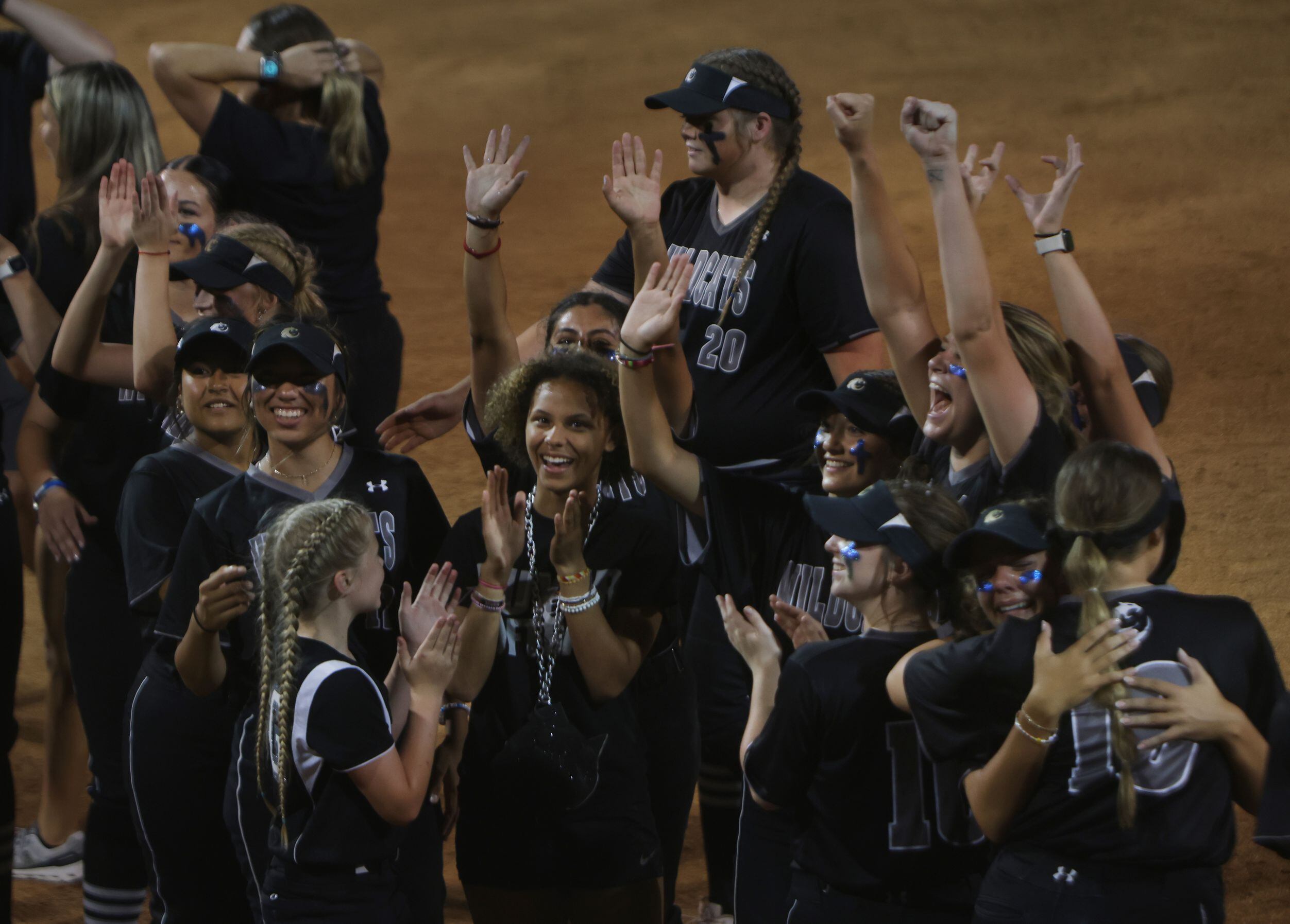 Denton Guyer players celebrate with fans in the stands over the team dugout following their...