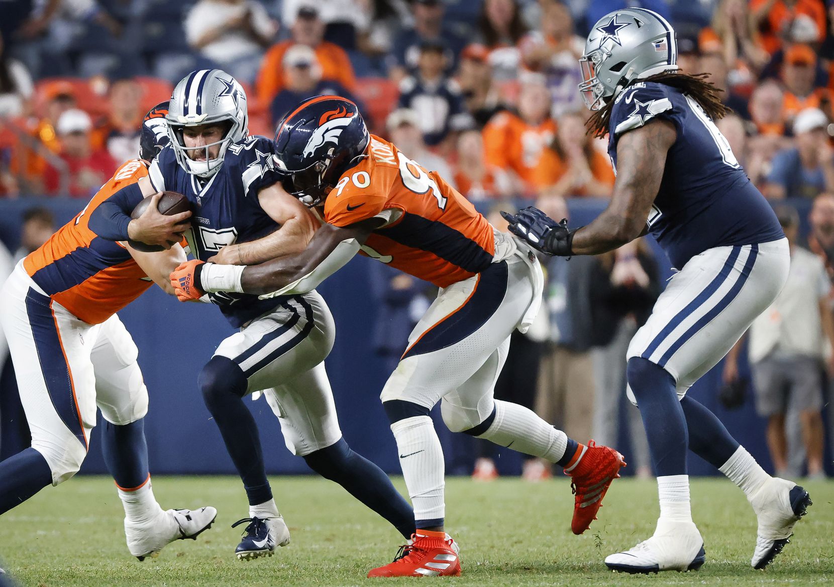 Dallas Cowboys quarterback Ben DiNucci (17) is sacked by Denver Broncos defensive end...