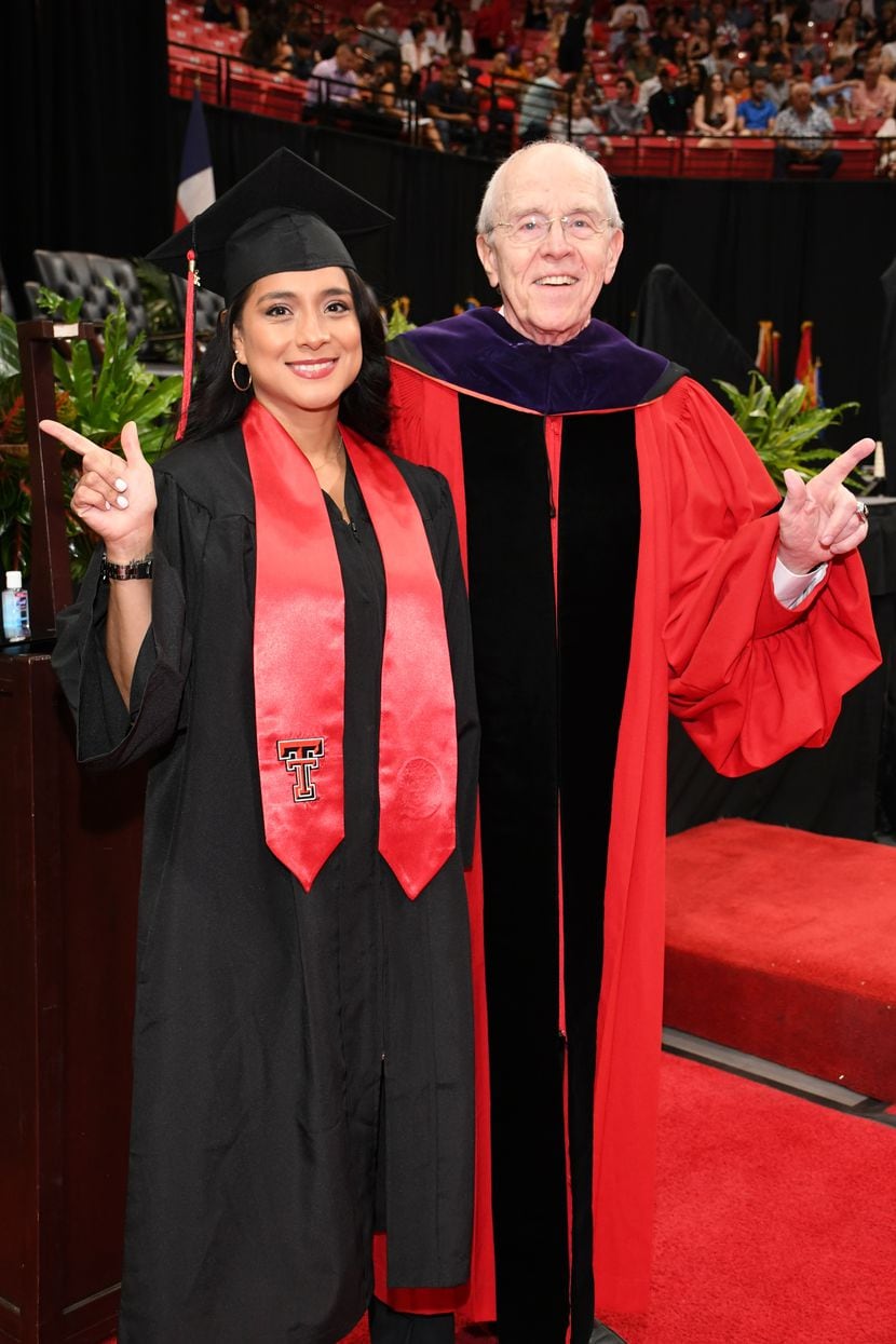 Erica Flores poses with Kent Hance, Texas Tech University's chancellor emeritus, holding up...