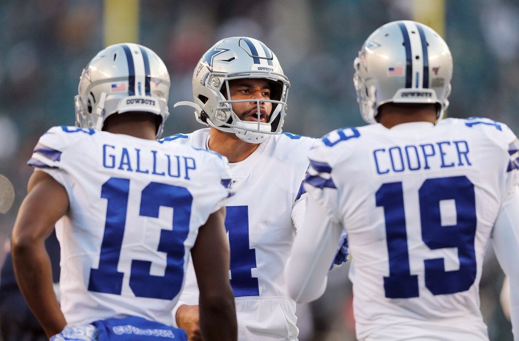 Dallas Cowboys quarterback Dak Prescott (4) talks with Dallas Cowboys wide receiver Michael...