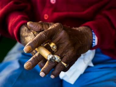 Richard Overton, 111, holds a cigar while sitting on his front porch on Thursday, May 25,...