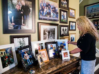 Diane Wallace rearranges framed photos of her son, Andy DeBusk, at her home. She said she...