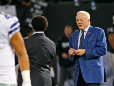 Dallas Cowboys owner Jerry Jones (right) is pictured on the field with Cowboys quarterback Dak Prescott (4) before a game against the Oakland Raiders at Oakland-Alameda County Coliseum in Oakland, Calif., on Sunday, Dec. 17, 2017.