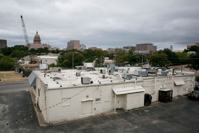 A view of the Texas State Capitol from the back lot of a nearby pizzeria in Austin, a site...