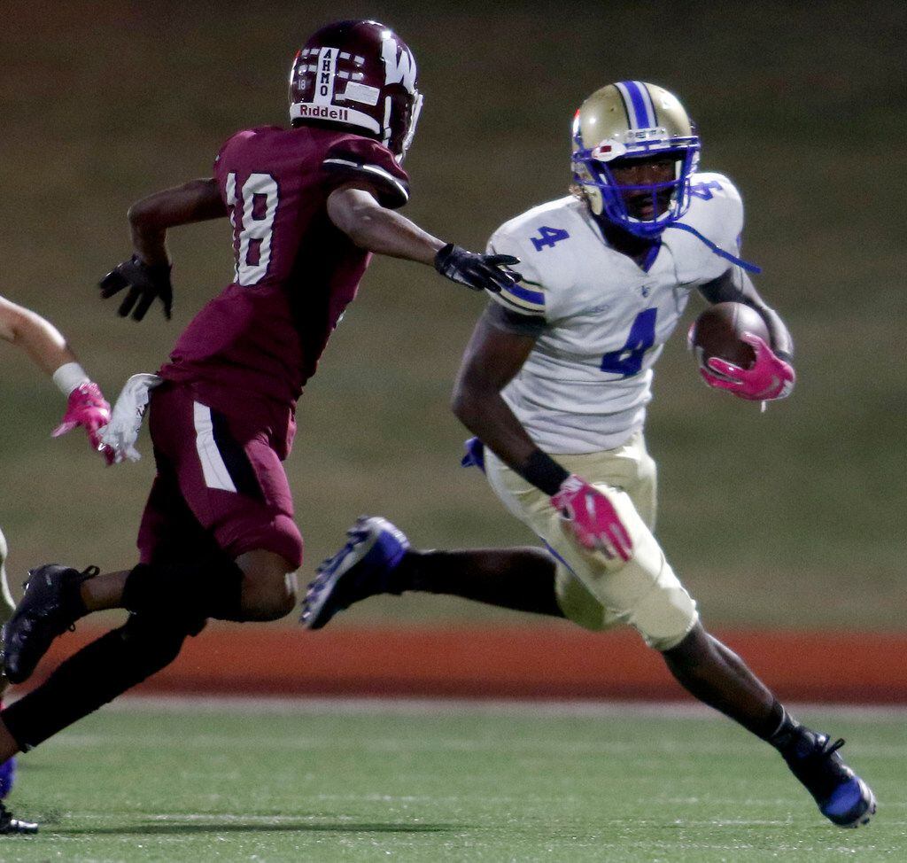 Garland Lakeview running back Camar Wheaton (4) looks into the secondary as he is pursued...