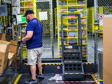 Sal Ribaul organizes packages at an Amazon fulfillment center in Coppell. Ribaul started...