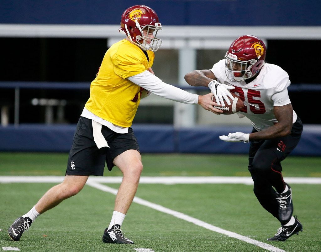 USC quarterback Sam Darnold (left) hands the ball to running back Ronald Jones II during practice at AT&T Stadium in Arlington, Texas, Monday, Dec. 25, 2017. USC will play Ohio State in Cotton Bowl on Dec. 29. (Jae S. Lee/The Dallas Morning News)