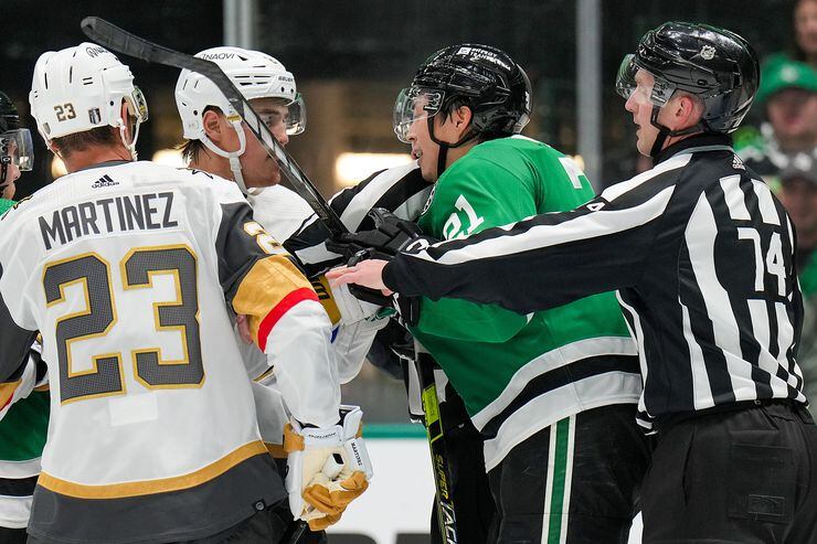 Officials try to separate Dallas Stars left wing Jason Robertson (21) from Vegas Golden...