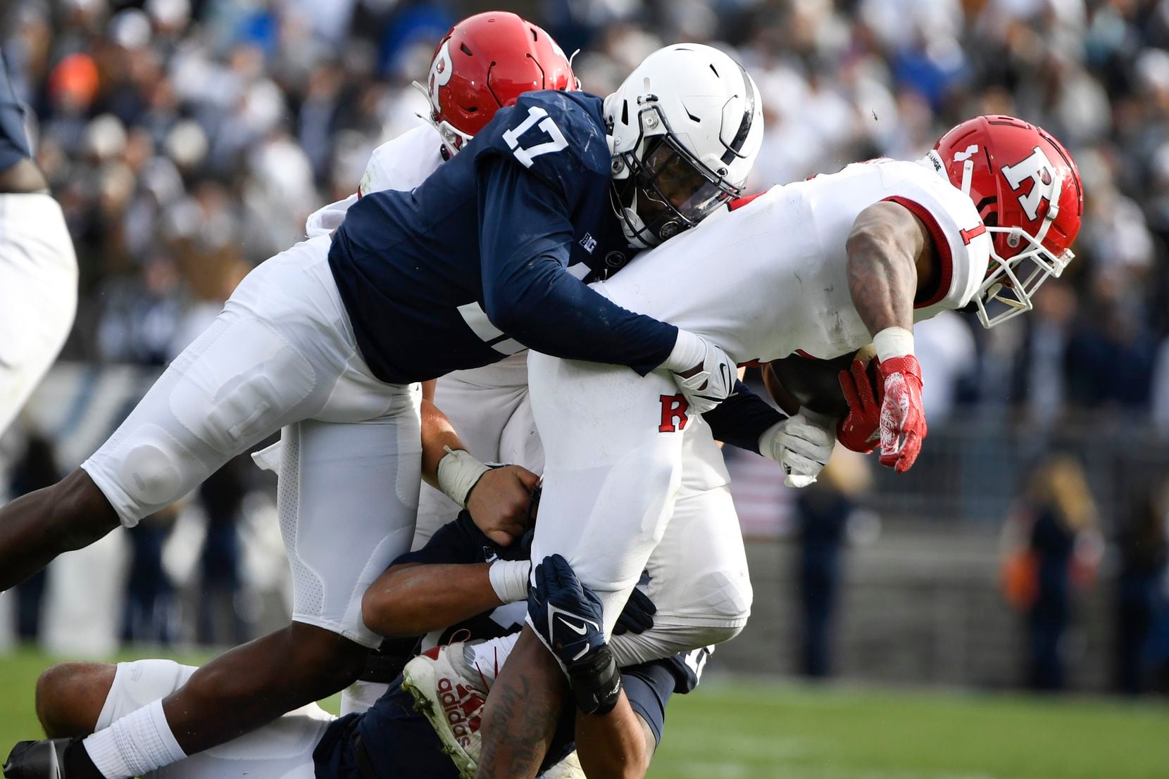 Penn State defensive end Arnold Ebiketie (17) tackles Rutgers running back Isaih Pacheco (1)...