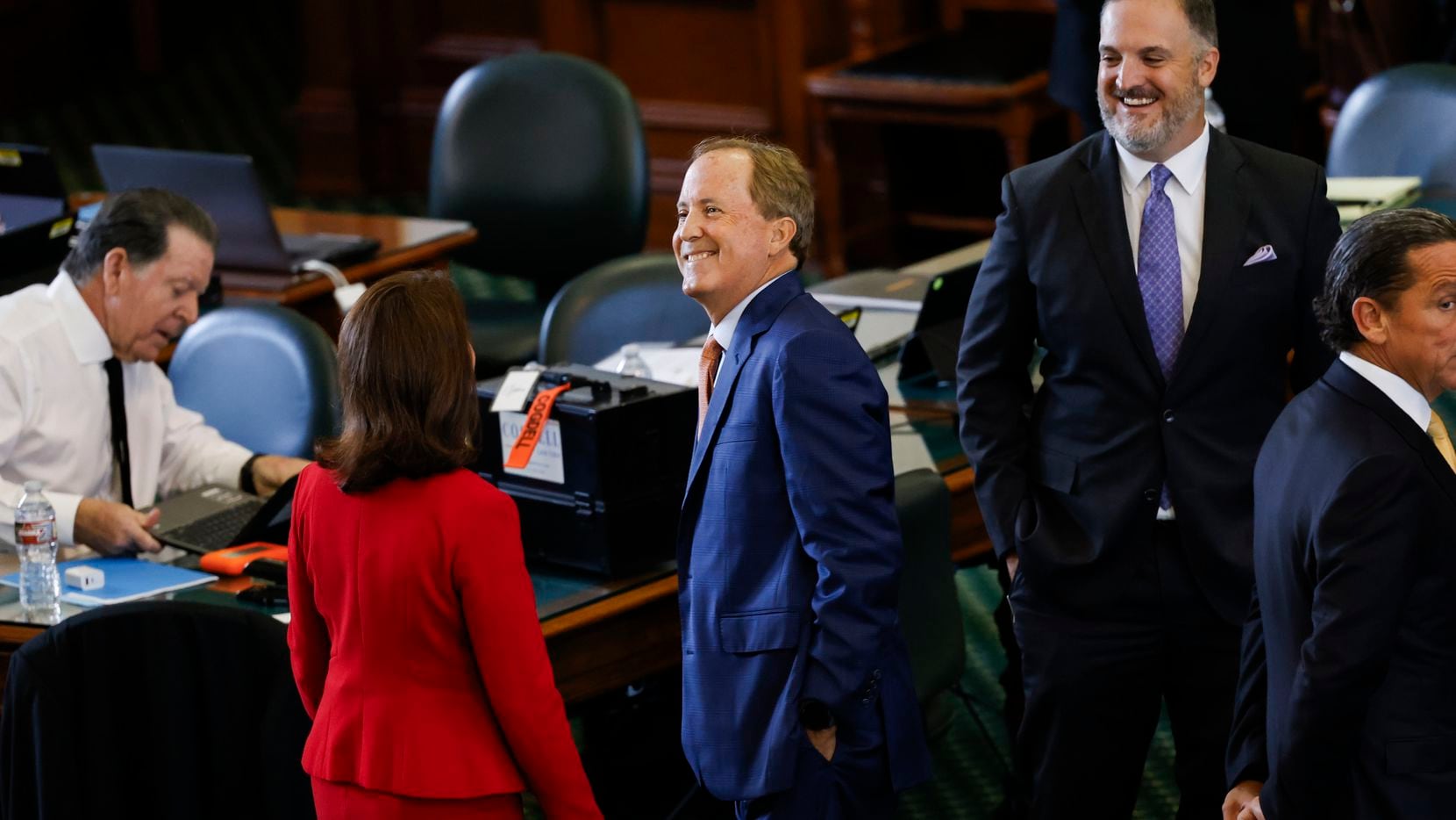 (From left) Lawyer Dan Cogdell sits as Sen. Angela Paxton, R-McKinney, greets her husband,...