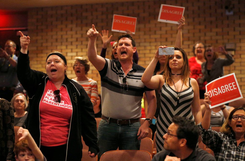 People shout to "vote him out" during a town hall meeting with Rep. Pete Sessions, R-Dallas,...