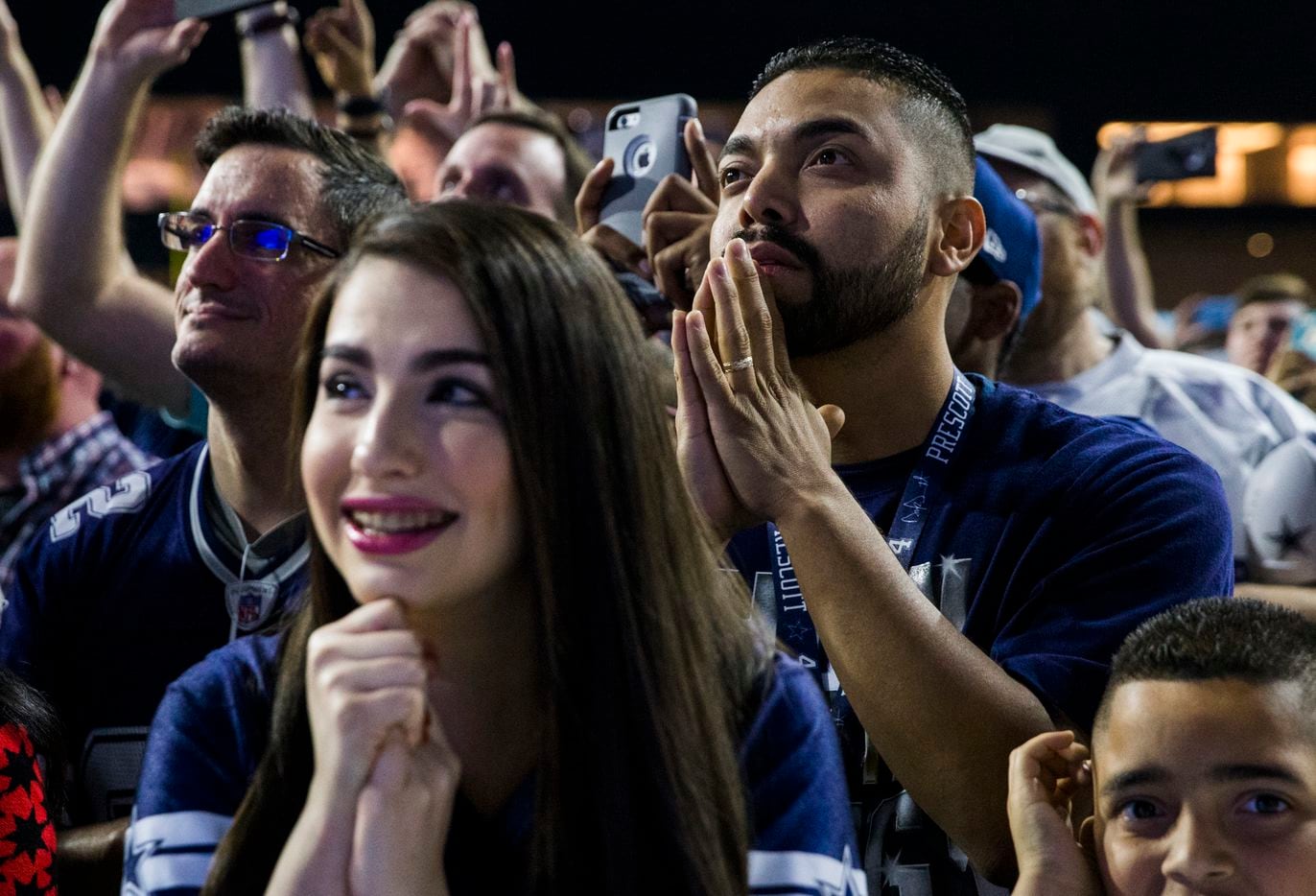 Dallas Cowboys fans Amber Williams and Jose Umanzor wait to hear the Cowboys' pick during the Dallas Cowboys' 2017 NFL Draft Party on Thursday, April 27, 2017, at The Star in Frisco. 
