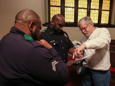 Detective M. Stampley (from left), Officer B. Joseph and volunteer Dennis Friedel figure out...