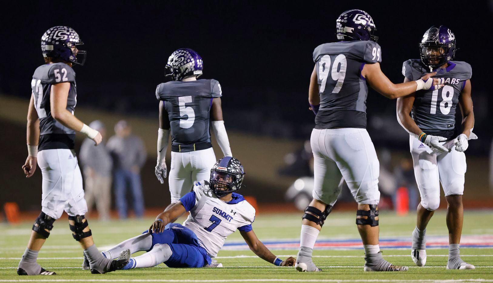Mansfield Summit senior quarterback David Hopkins (7) is slow to get up after being hit by...