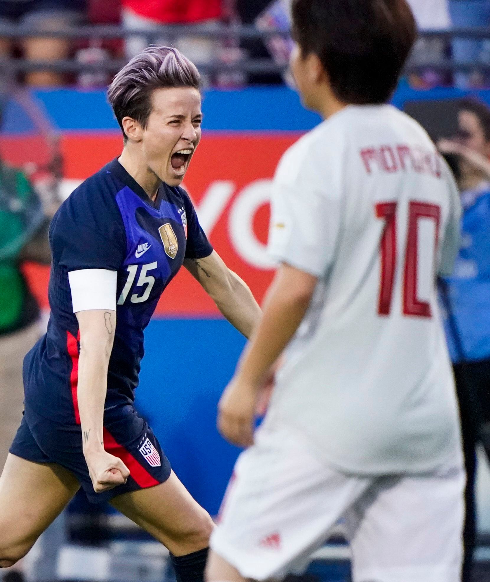 USA forward Megan Rapinoe celebrates after scoring on a free kick as Japan midfielder Yuka...