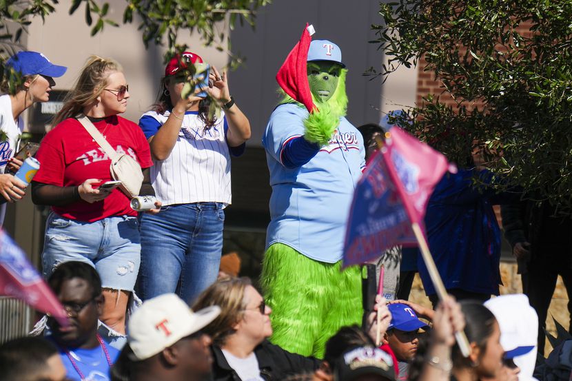 Fans cheer along the parade route during the Texas Rangers World Series victory parade,...