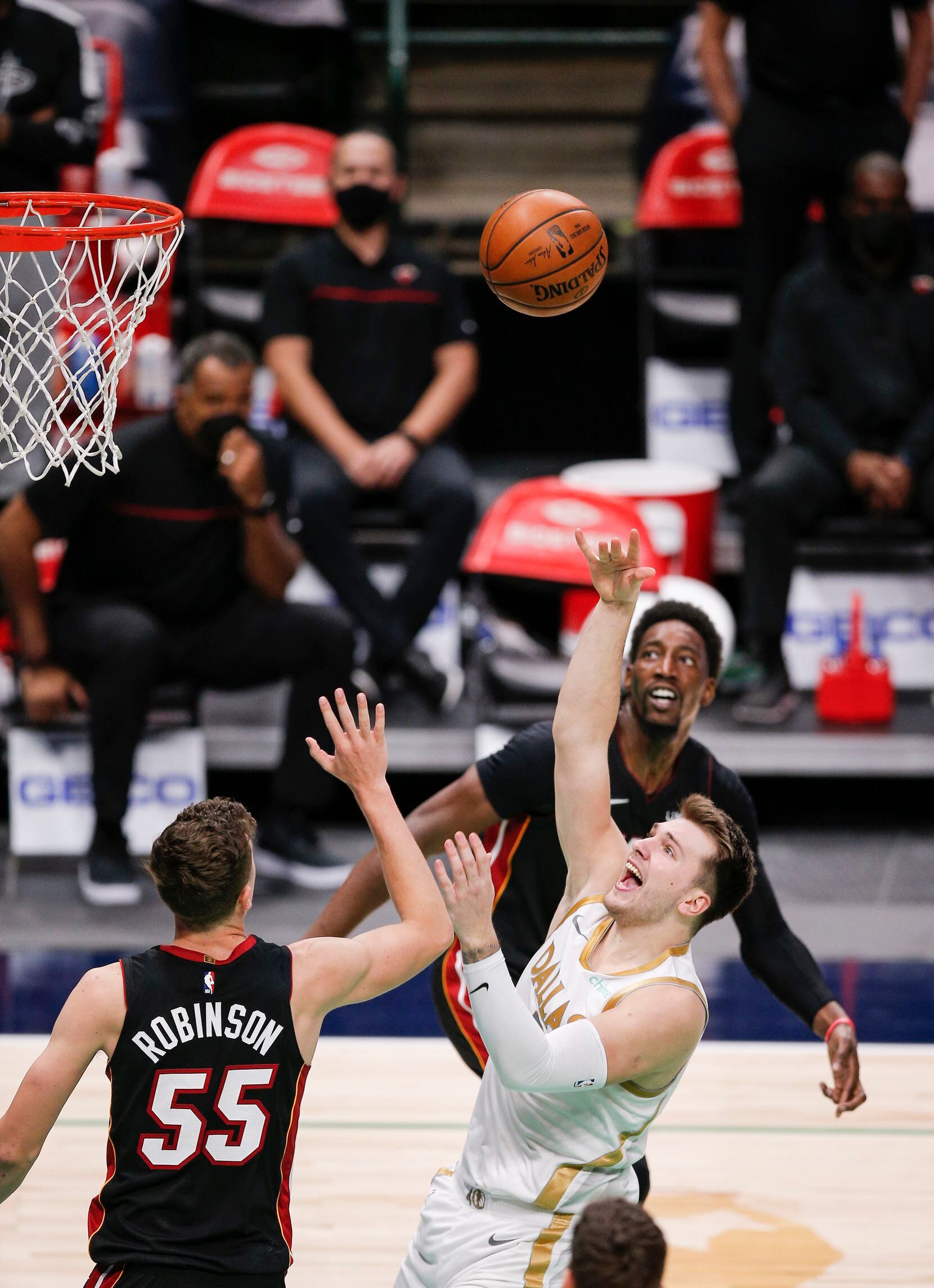 Dallas Mavericks guard Luka Doncic (77) attempts a shot as Miami Heat forward Duncan...