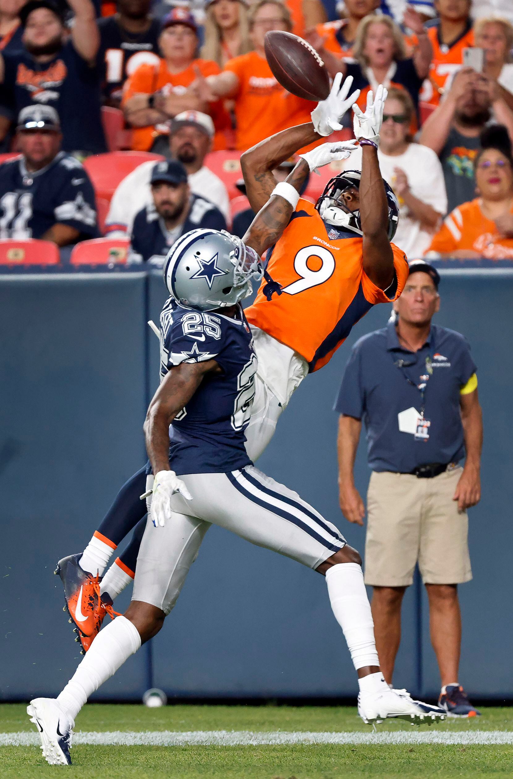 Denver Broncos wide receiver Kendall Hinton (9) pulls down a touchdown pass in front of...