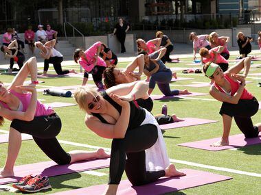 Susan G. Komen supporters participate in project:OM, a cancer research yoga event, held at...