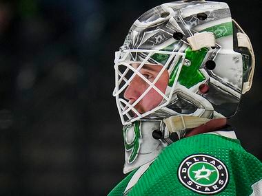 Dallas Stars goaltender Jake Oettinger (29) looks out from the net during the second period...