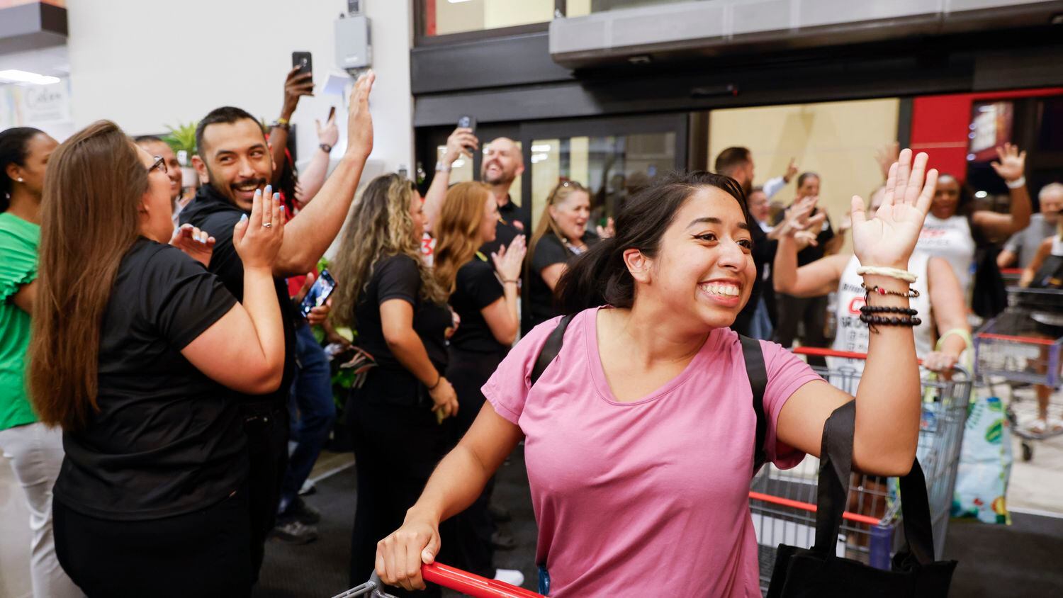 Jessica Bustamante, 24, (center) of McKinney, the first person to enter the supermarket,...