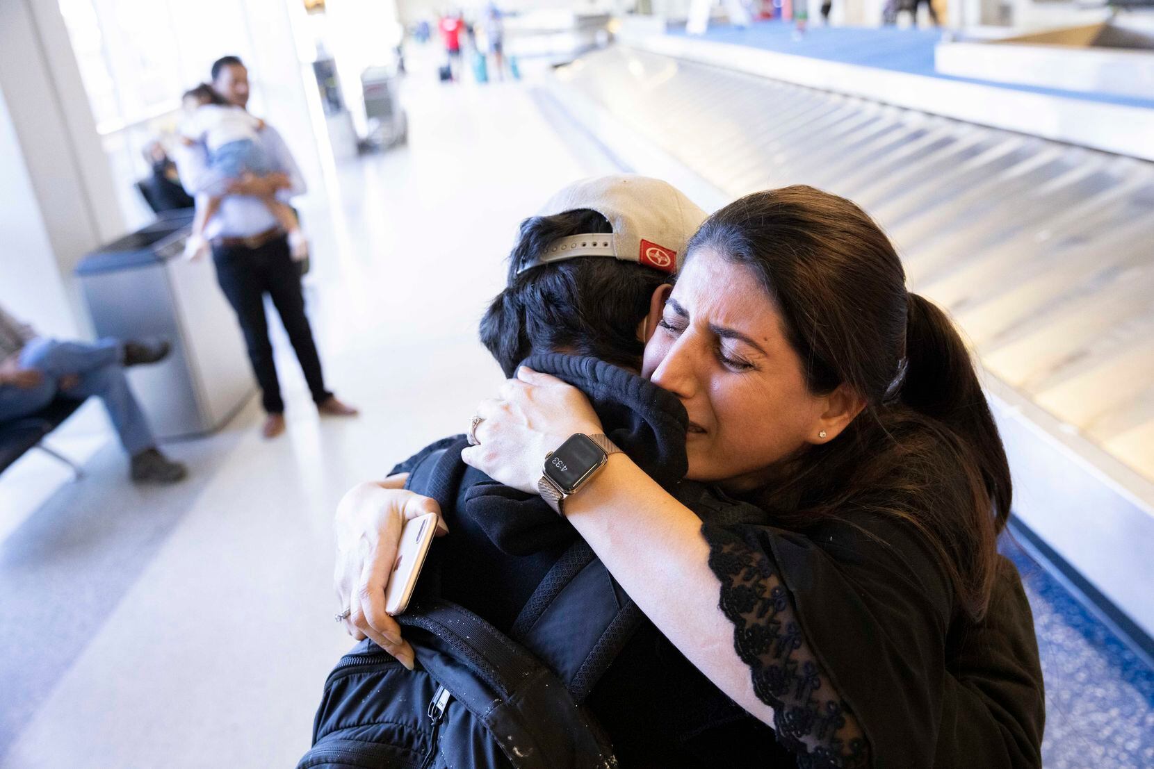 Atefa Sharifi (right) hugged her son Saeed Sharifi, 15, after being reunited on Tuesday at DFW International Airport. Saeed flew from Fort Bliss, where he stayed after arriving from Afghanistan. 