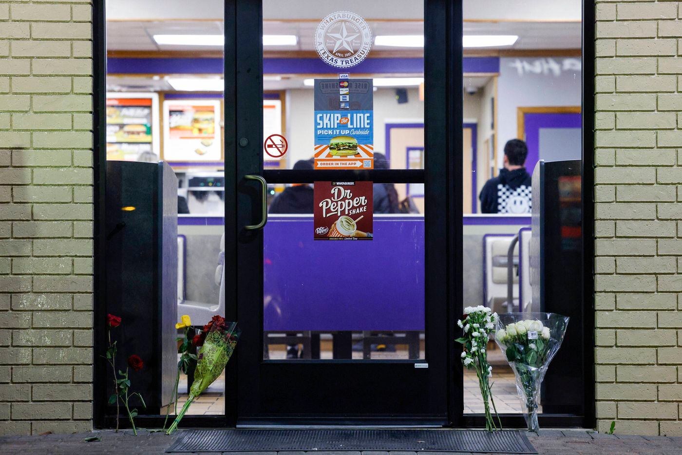 Bouquets of flowers sit outside the Whataburger where Zechariah Trevino, 17, worked in south...