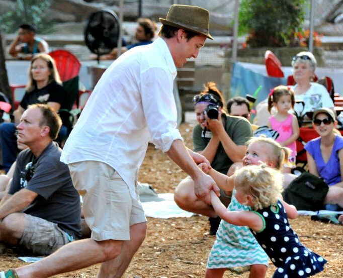 David Williams dances to with Brooklyn and Abby at a Safari Nights concert at the Dallas Zoo. 