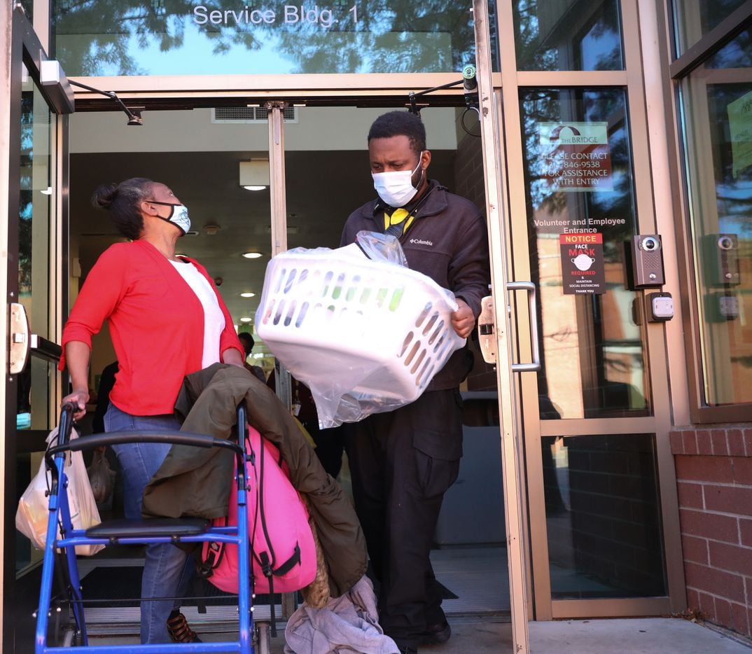 Patricia Freeman (left) exits The Bridge Homeless Recovery Center on November 19, 2021 as part of her sendoff to a new apartment. Freeman got help getting her new home through the Dallas Rapid Rehousing program. (Liesbeth Powers/Special Contributor)