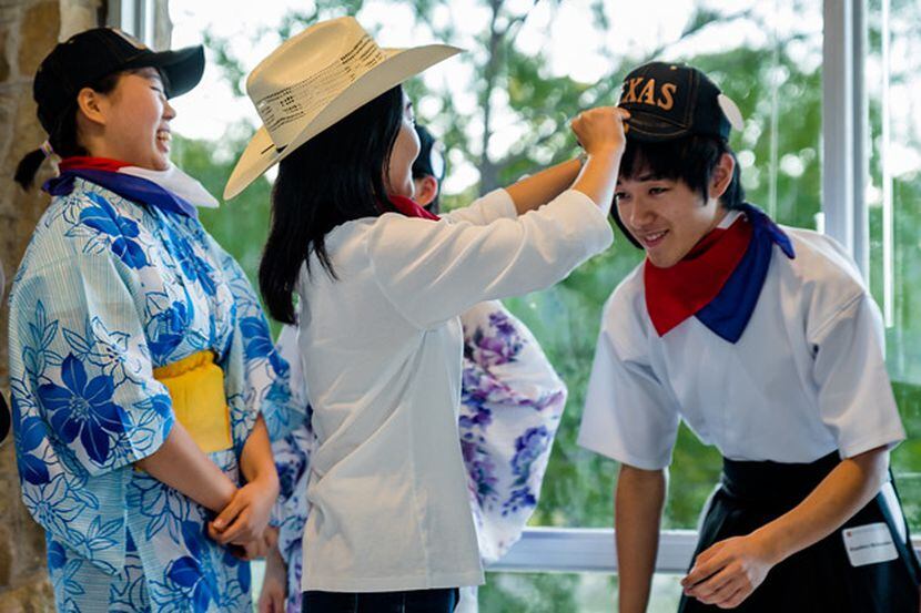 Mina Takamatsu presents souvenirs to Kiyohiro Watanabe, one of six Young Ambassadors...