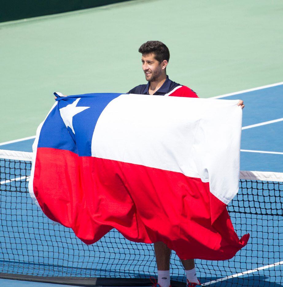 Hans Podlipnik of Chile celebrates with a Chilean national flag during the Davis Cup first...