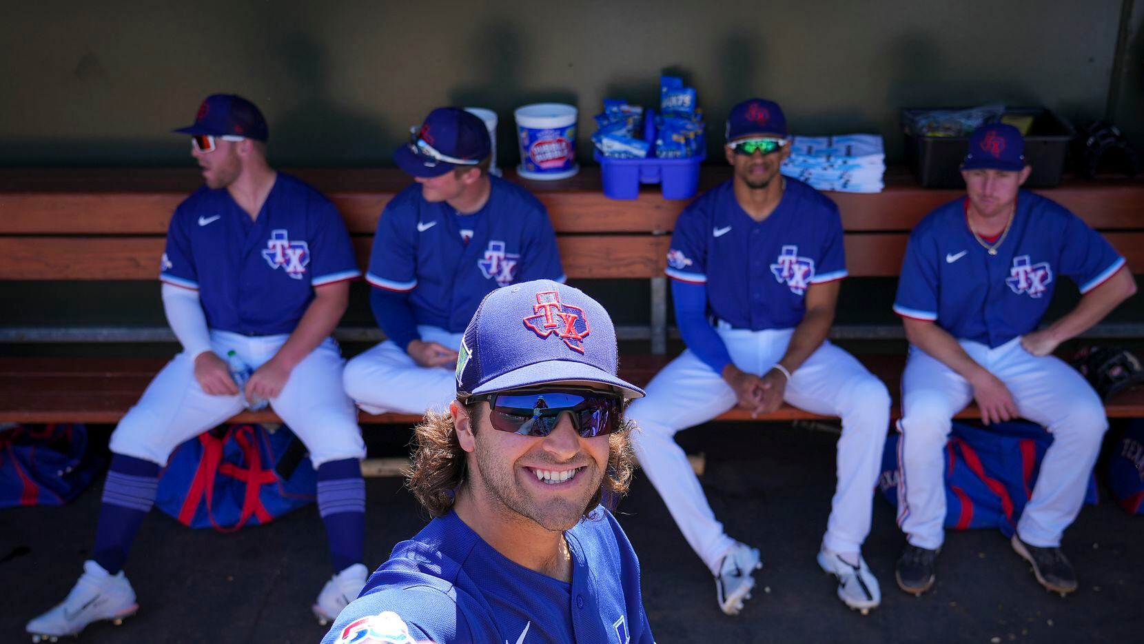 Texas Rangers infielder Josh Smith smiles in the dugout before a spring training game...