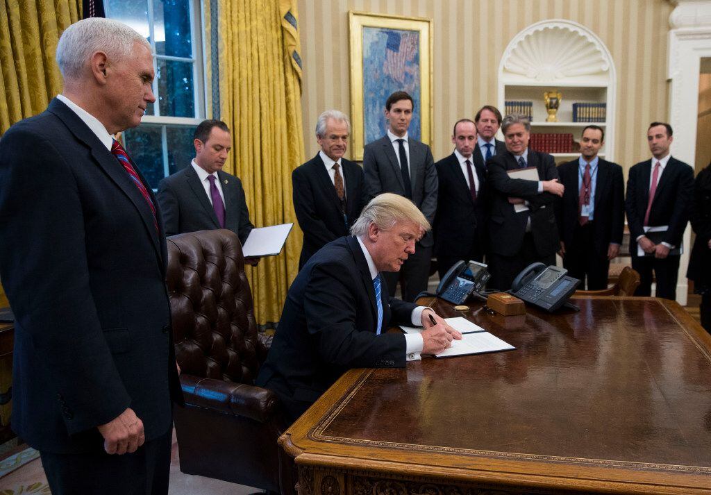 President Donald Trump signed executive orders in the Oval Office on Monday, his first...