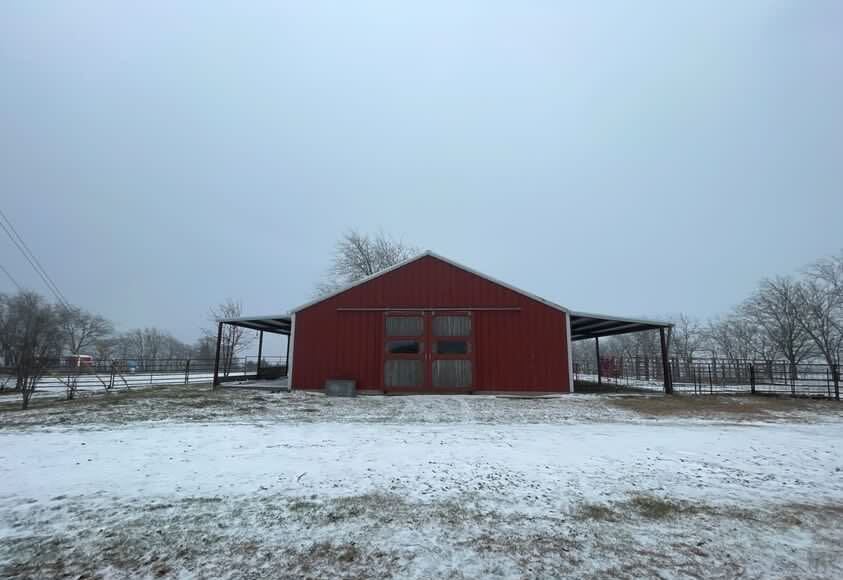 Snow coats a barn in Howe, Texas on Jan. 31, 2023.