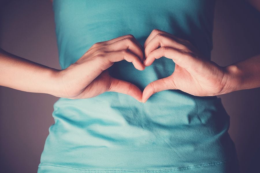 Woman hands making a heart shape on her stomach, healthy bowel degestion, probiotics  for...