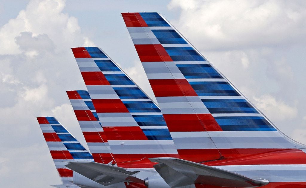 FILE - This July 17, 2015, file photo shows the tails of four American Airlines passenger...