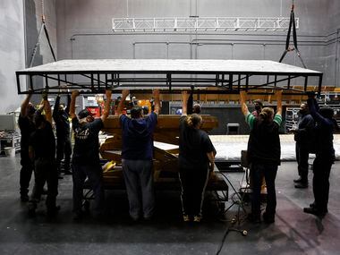The AT&T Performing Arts Center crew load a stage piece made by Dallas Stage Scenery onto a...