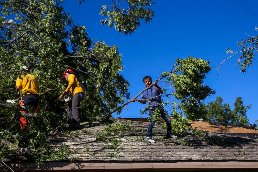 This file photo shows members of Texas Baptist Men and Islamic Relief USA clear tornado...