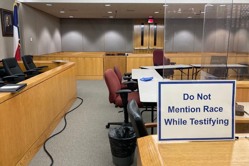 A sign prohibiting discussions of race is posted inside grand jury room witness boxes.